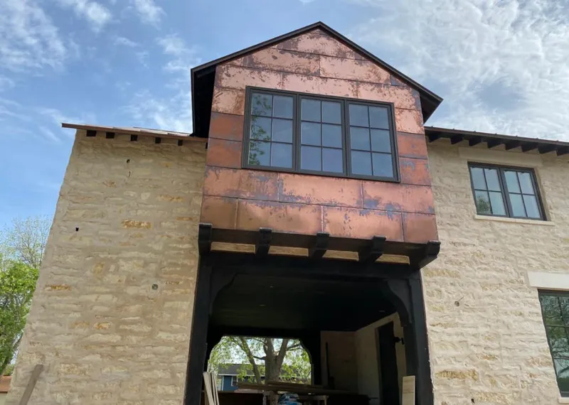 Copper metal panel facade on a stone building for Skylight Installation in Montgomery